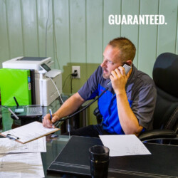 man answering phone and taking client information