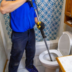 man plunging toilet