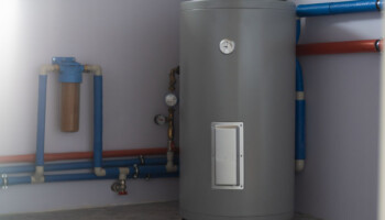 Tank for indirect heating of boiler, flow filter for fine cleaning, boiler piping and meters in boiler room of private house